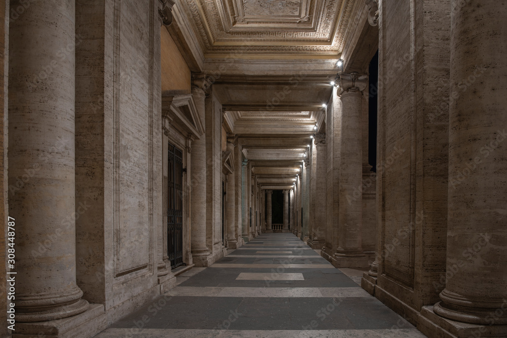 Long empty archway (tunnel) made from marble columns and sculptures