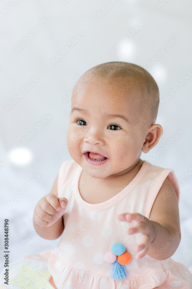 Cute little Asian baby sitting and play with happiness select focus shallow depth of field Cute little Asian baby sitting and play with happiness select focus shallow depth of field