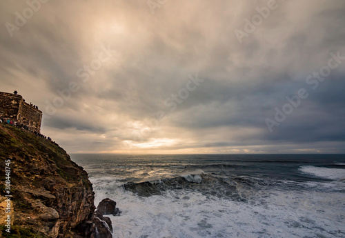 Obraz na płótnie Nazare, Portugal: Nov 15, 2019: massive waves as seen from Nazare Lighthouse in Nazare, Portugal w salonie