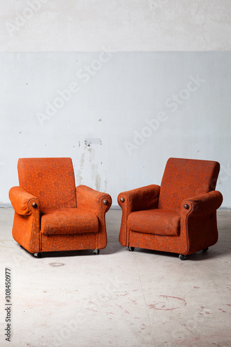 Minimal loft interior design. Studio, art atelier with two armchairs from sixties. Vintage furniture in abandoned factory. photo