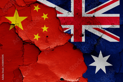flags of China and Australia painted on cracked wall