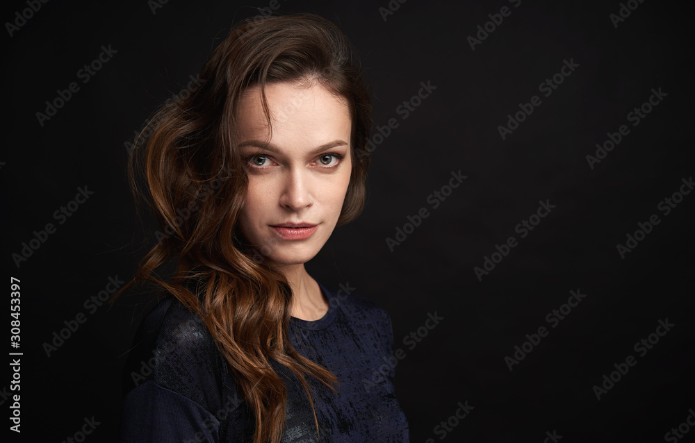 Portrait of beautiful woman with curly hair isolated on black