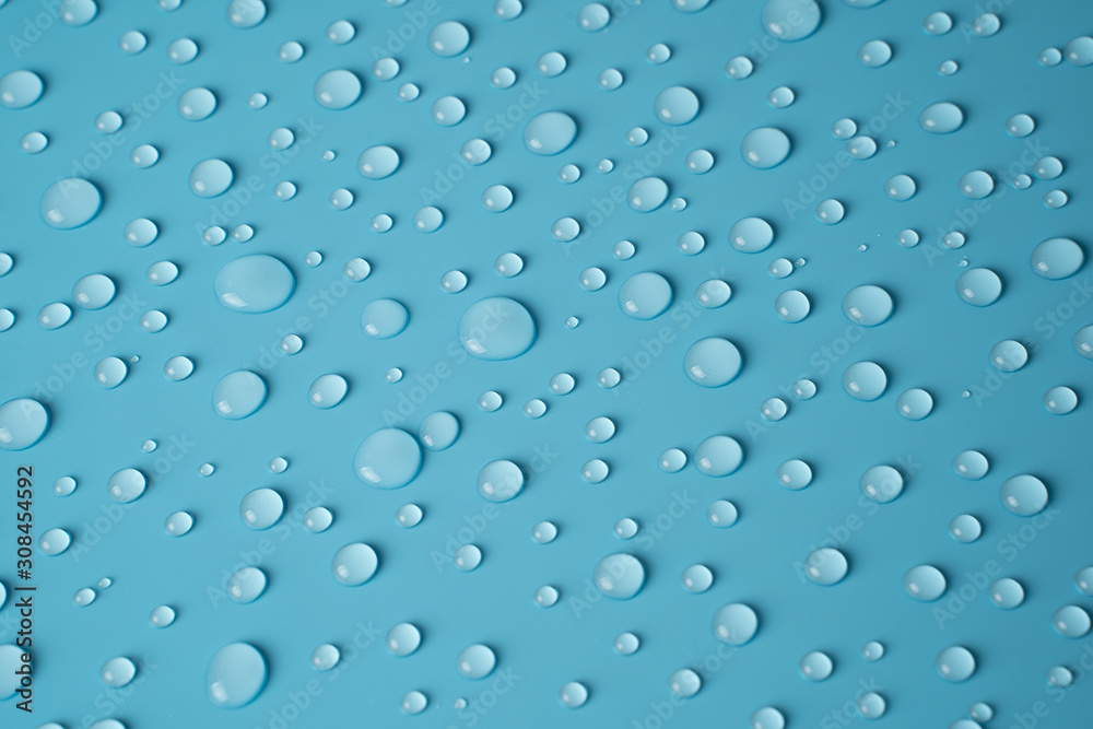 Transparent water drops on a blue background. The view from the top.