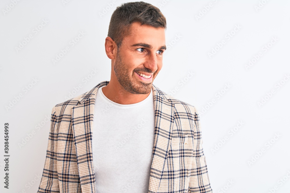 Young handsome business man wearing elegant jacket over isolated background looking away to side with smile on face, natural expression. Laughing confident.