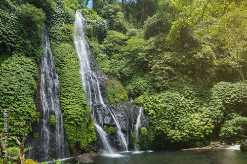 Beautiful waterfall in Bali in its ecosystem in green