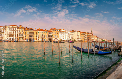 Magical panoramic view during sunset over gondolas in Venice, Grand Canal and its historical center, Venice, Italy, summer time, blue sky © neurobite