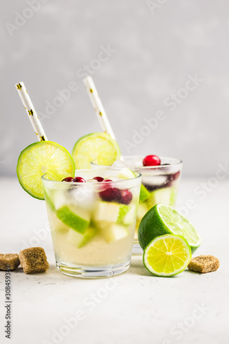 Festive cocktail, iced citrus, cranberry, apple drink. Selective focus, copy space.
