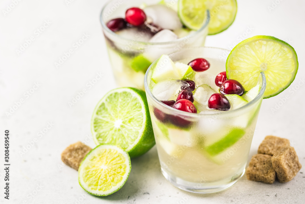 Festive cocktail, iced citrus, cranberry, apple drink. Selective focus, copy space.