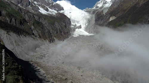 An aerial view of Mt. Gongga (Gonggashan, Minya Konka), the highest mountain of Sichuan, China (7 556 m), with its Glacier no. 1 in Hailougou valley and clouds slowly covering the glacier