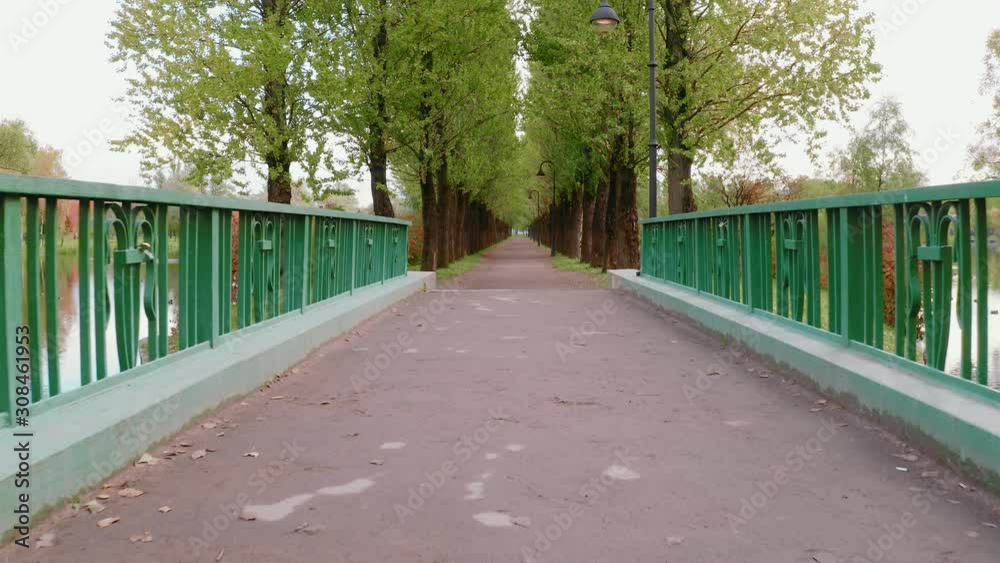 Recreation Park with Pond and Sunny Alley with Lush Trees on Warm Sunny Morning. Recreation Park with Pond and Sunny Alley with Lush Trees on Warm Sunny Morning.