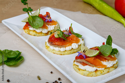 round sandwiches with salmon and red caviar.
