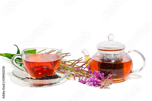 Cup of herbal tea and teapot with blooming Chamerion angustifolium (common names: fireweed, great willowherb, rosebay willowherb) isolated on white background