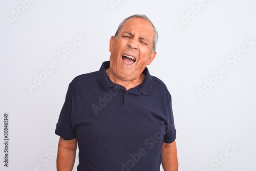 Senior grey-haired man wearing black casual polo standing over isolated white background winking looking at the camera with sexy expression, cheerful and happy face.