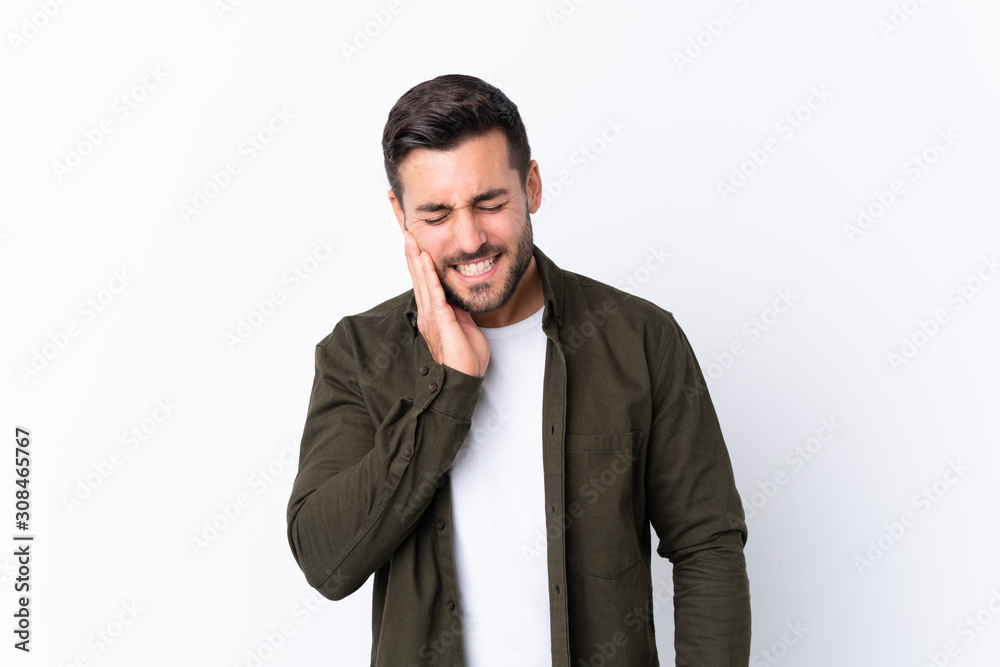 Young handsome man with beard over isolated white background with toothache Young handsome man with beard over isolated white background with toothache