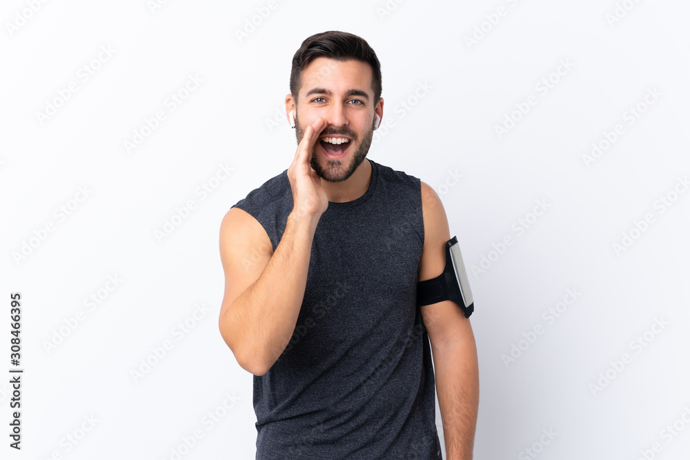 Young sport handsome man with beard over isolated white background shouting with mouth wide open Young sport handsome man with beard over isolated white background shouting with mouth wide open