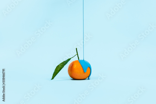 Orange poured blue paint on the classic blue background.