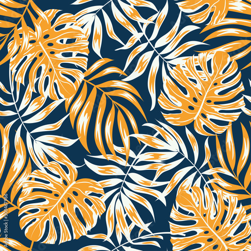 Tropical seamless pattern with yellow plants and leaves on a blue background. Trendy summer Hawaii print. Floral pattern. Jungle leaves. Botanical pattern. Vector background for various surface. 