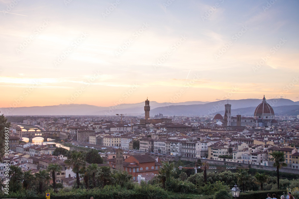 View over Arno river, Florence Cathedral and Palazzo Vecchio tower at sunset.  Piazzale Michelangelo, Florence, Italy.
