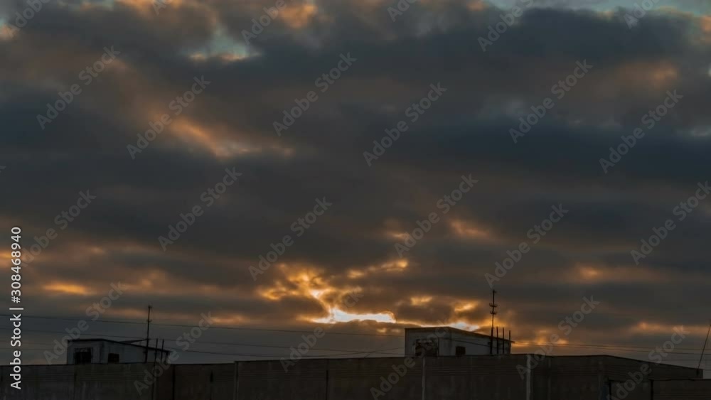 Cloudy sky 4K time lapse. City skyline and dramatic sunset with clouds and orange sky. Natural background, cloudscape. Wind energy. Cloudy sky 4K time lapse. City skyline and dramatic sunset with clouds and orange sky. Natural background, cloudscape. Wind energy.