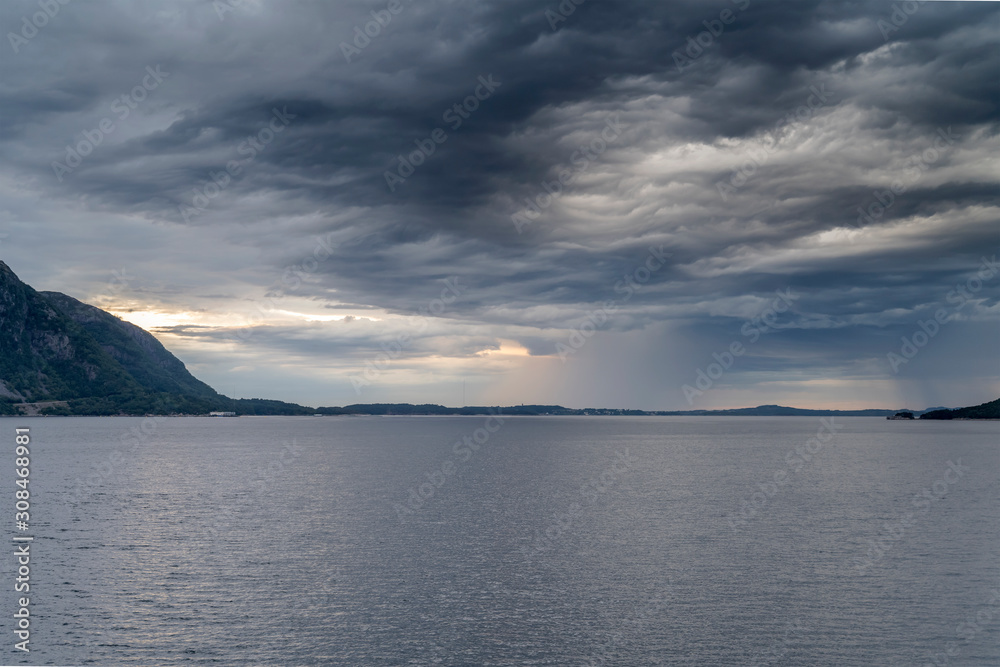 heavy clouds and distant rain on fjord, Molde, Norway
