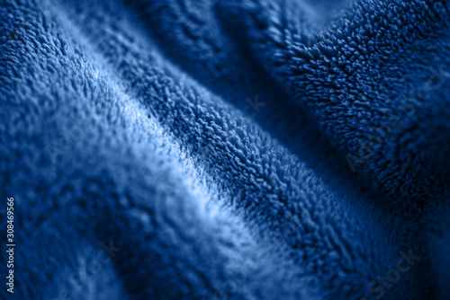 Blue delicate soft background of fur plush smooth fabric. Texture of fleecy blanket textile