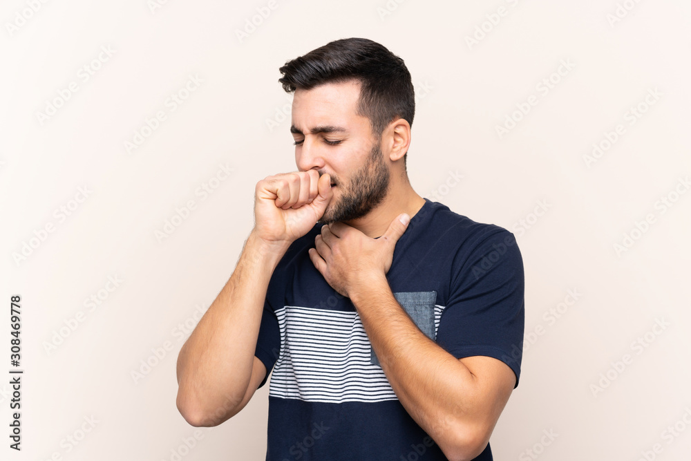 Young handsome man with beard over isolated background is suffering with cough and feeling bad Young handsome man with beard over isolated background is suffering with cough and feeling bad