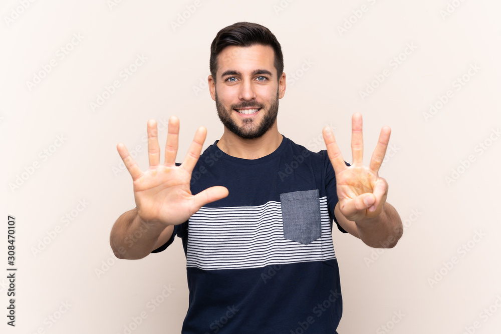 Young handsome man with beard over isolated background counting eight with fingers Young handsome man with beard over isolated background counting eight with fingers