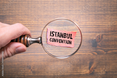 Photography Istanbul convention. Man's hand, holding magnifying glass