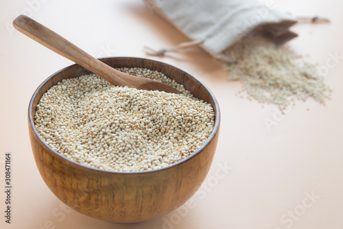 Raw quinoa close up in a wooden bowl