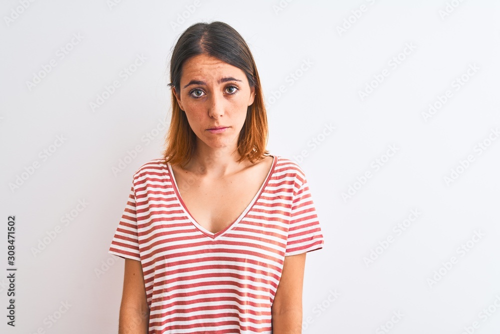 Beautiful redhead woman wearing casual striped red t-shirt over isolated background depressed and worry for distress, crying angry and afraid. Sad expression. Beautiful redhead woman wearing casual striped red t-shirt over isolated background depressed and worry for distress, crying angry and afraid. Sad expression.