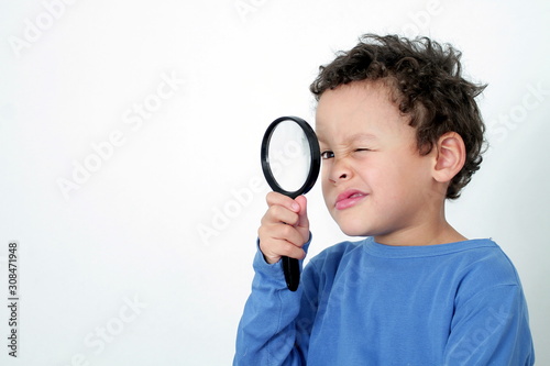 boy with magnifying glass ready to explore on white background stock photo