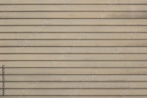 The wall of the house is laid out horizontally with beige boards.Texture or background