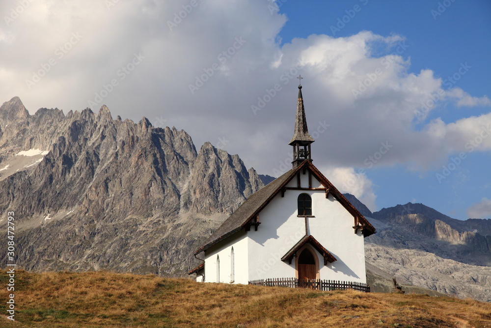 Small chapel and church close to Aletsch glacier landscapes in the Swiss alps with mountains and valleys
