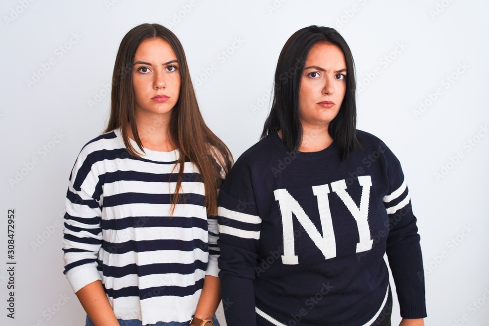 Young beautiful women wearing casual clothes standing over isolated white background skeptic and nervous, frowning upset because of problem. Negative person. Young beautiful women wearing casual clothes standing over isolated white background skeptic and nervous, frowning upset because of problem. Negative person.