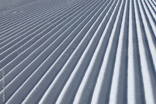 Groomed snow perfect parallel white lines in Swiss alps