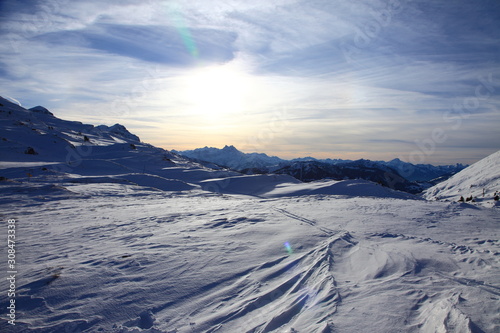 Winter sunset on top of summit in the snow covered Swiss alps