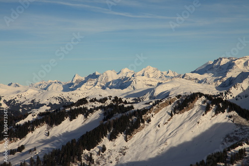 Winter sunset on top of summit in the snow covered Swiss alps © Alberto Vezendi