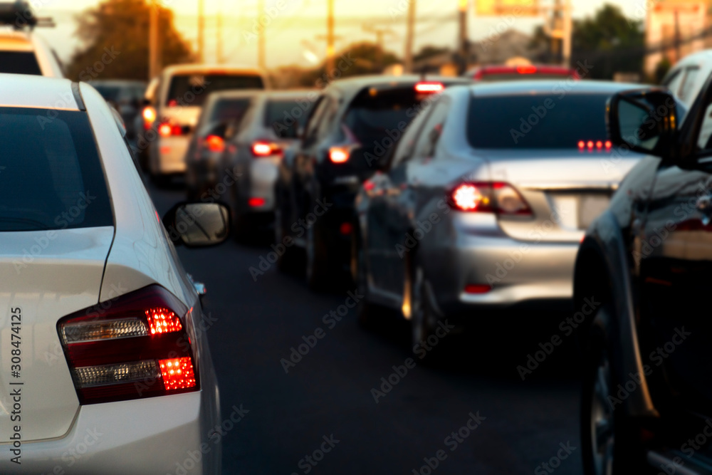 Luxury of white car stop on the asphalt road. Open brake light. Traffic jam during rush hour.