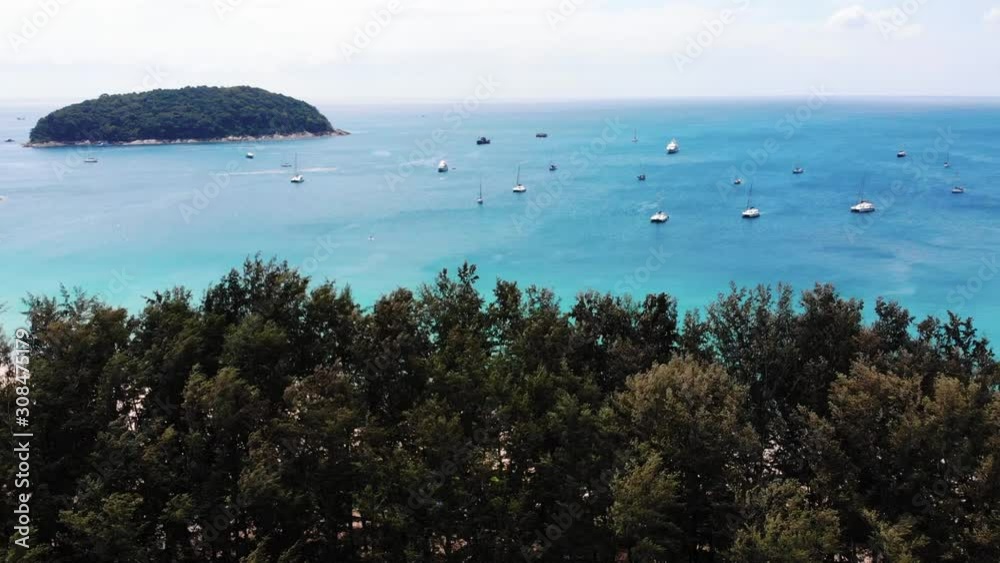 Aerial Over Trees To Reveal Beach And Turquoise Waters Of Andaman Sea With Boats Aerial Over Trees To Reveal Beach And Turquoise Waters Of Andaman Sea With Boats