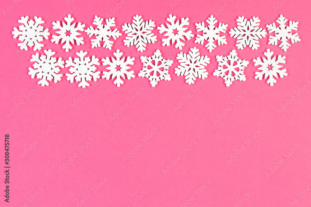 Top view of winter ornament made of white snowflakes on colorful background. Happy New Year concept with copy space