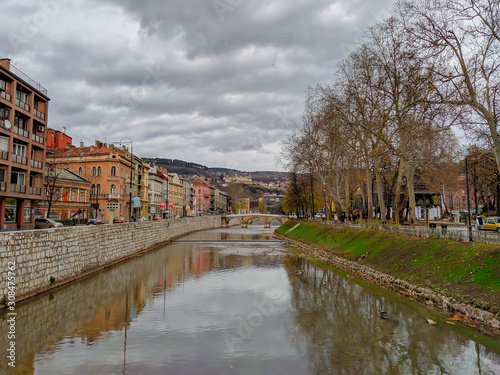 Beautiful view of Miljacka river in Sarajevo, Bosnia. Historical buildings and stone bridges in old part of the town.