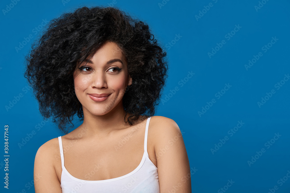 Mixed race woman lookingto side over blue background Mixed race woman lookingto side over blue background