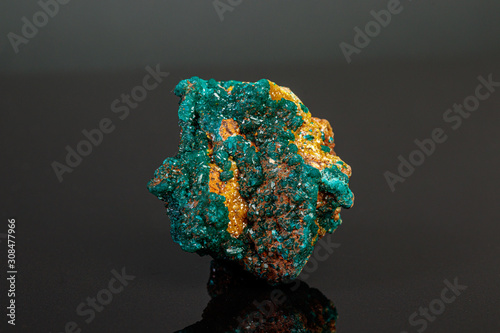 macro mineral stone Dioptase on a gray background