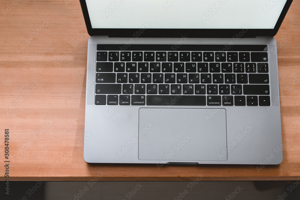 Conceptual workspace, Laptop computer with blank white screen on table, blurred background. use in Traditional Chinese Alphabet operating system. Conceptual workspace, Laptop computer with blank white screen on table, blurred background. use in Traditional Chinese Alphabet operating system.