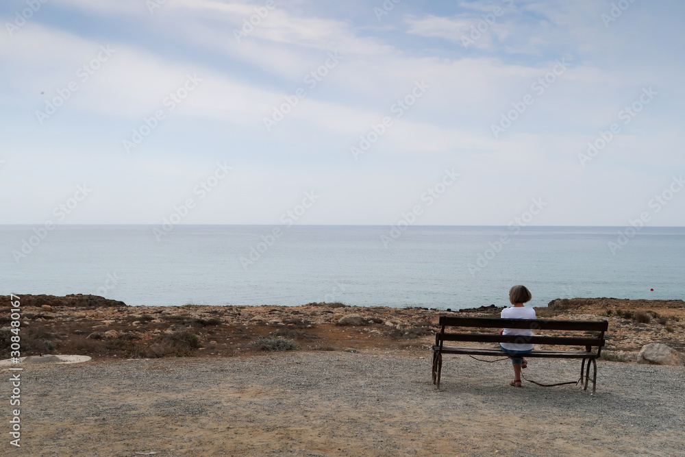 A woman contemplating the boundless distance of the sea A woman contemplating the boundless distance of the sea