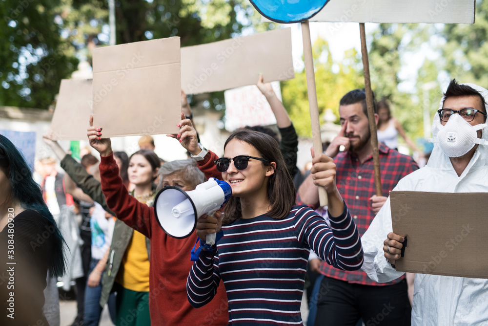 Obraz premium People with placards and amplifier on global strike for climate change.