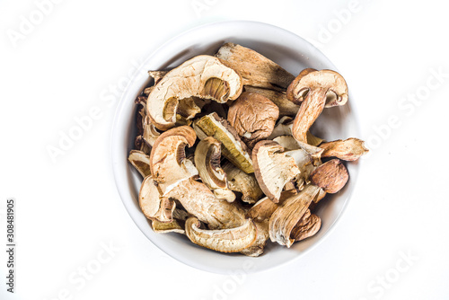 Dried forest organic mushrooms. White background top view copy space