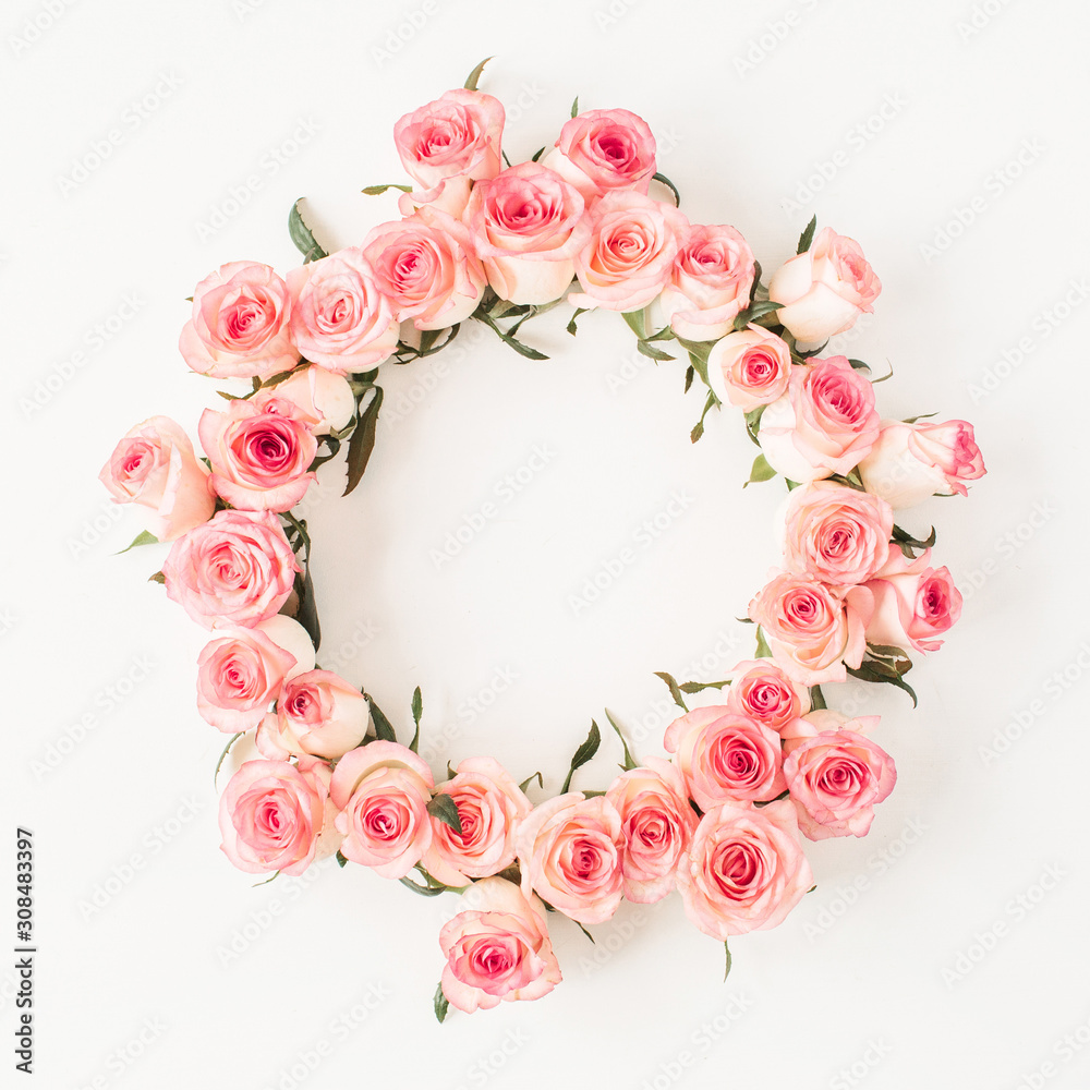 Flat lay frame border with blank copy space mockup made of pink rose flower buds on white background. Top view floral concept.