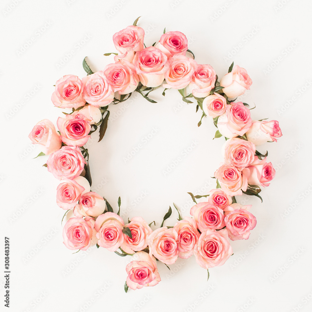 Flat lay frame border with blank copy space mockup made of pink rose flower buds on white background. Top view floral concept. Flat lay frame border with blank copy space mockup made of pink rose flower buds on white background. Top view floral concept.