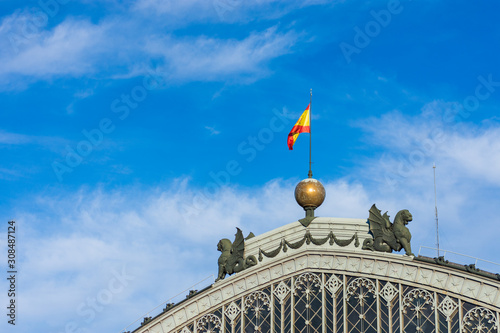 Spain flag on the facade of the railway station in the city of Madrid.